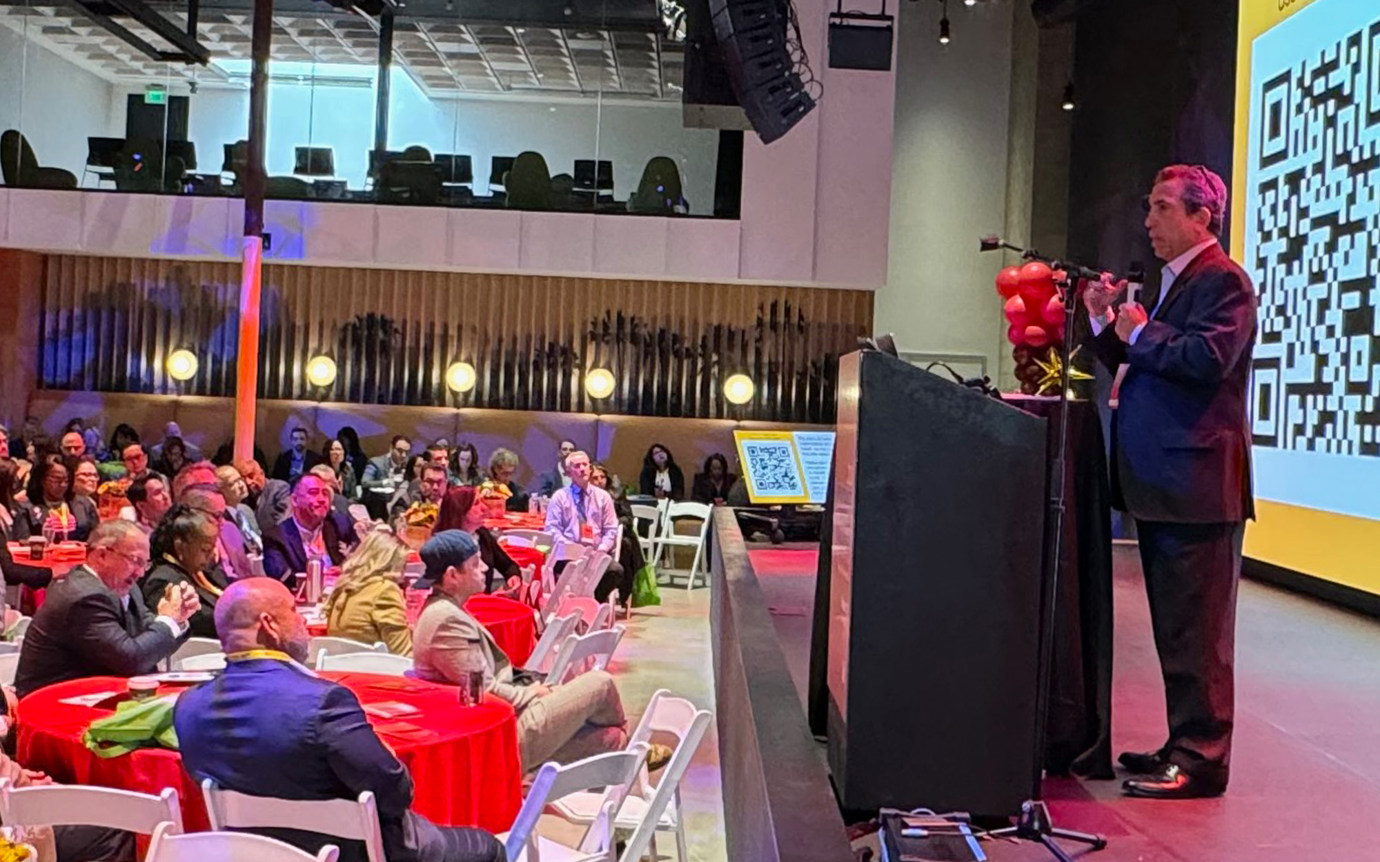 Alan Arkatov speaks at event