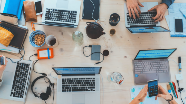 People using laptops on a desk